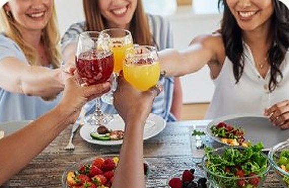 Friends toasting with drinks in the evening